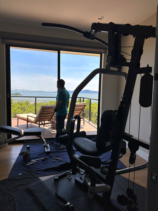 Expert fitness repair service technician servicing elliptical machine. 11